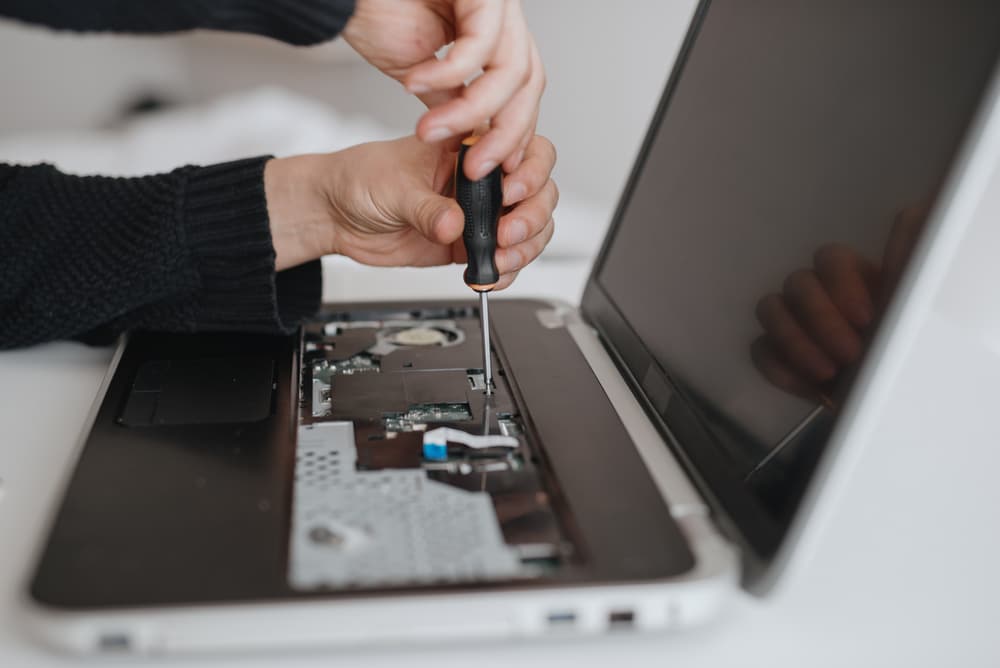 A view of a disembling a laptop back side to remove hard drive