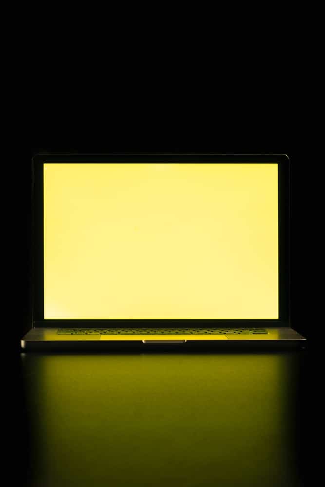 A view of a laptop with a yellow display screen