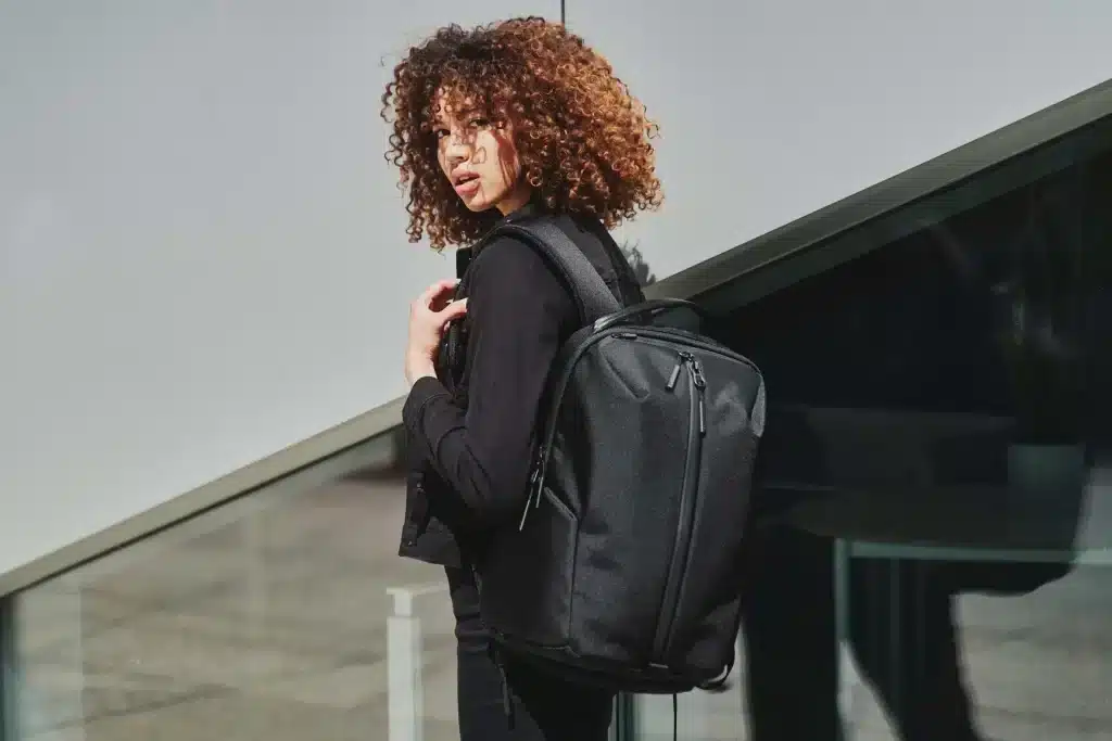 A backview of a girl carrying the Aer Fit Pack Laptop Bag