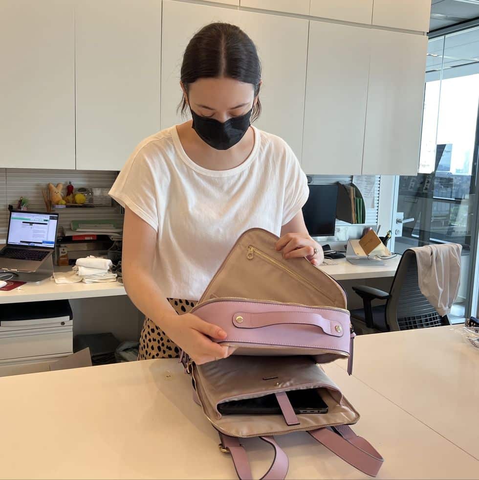 A woman keeping her laptop inside a bag