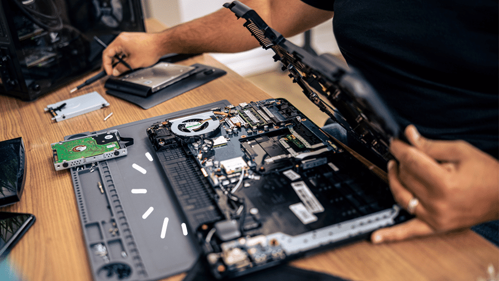 A view of a person replacing the hardware of a laptop