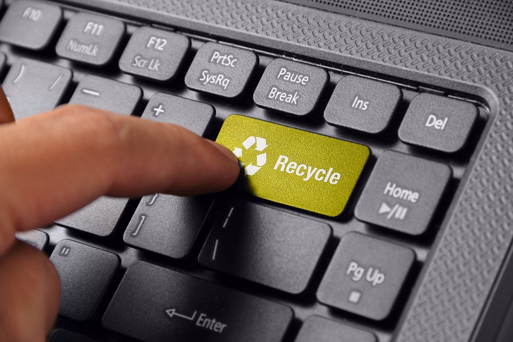 A view of a person touching the recycle button on the laptop keypad