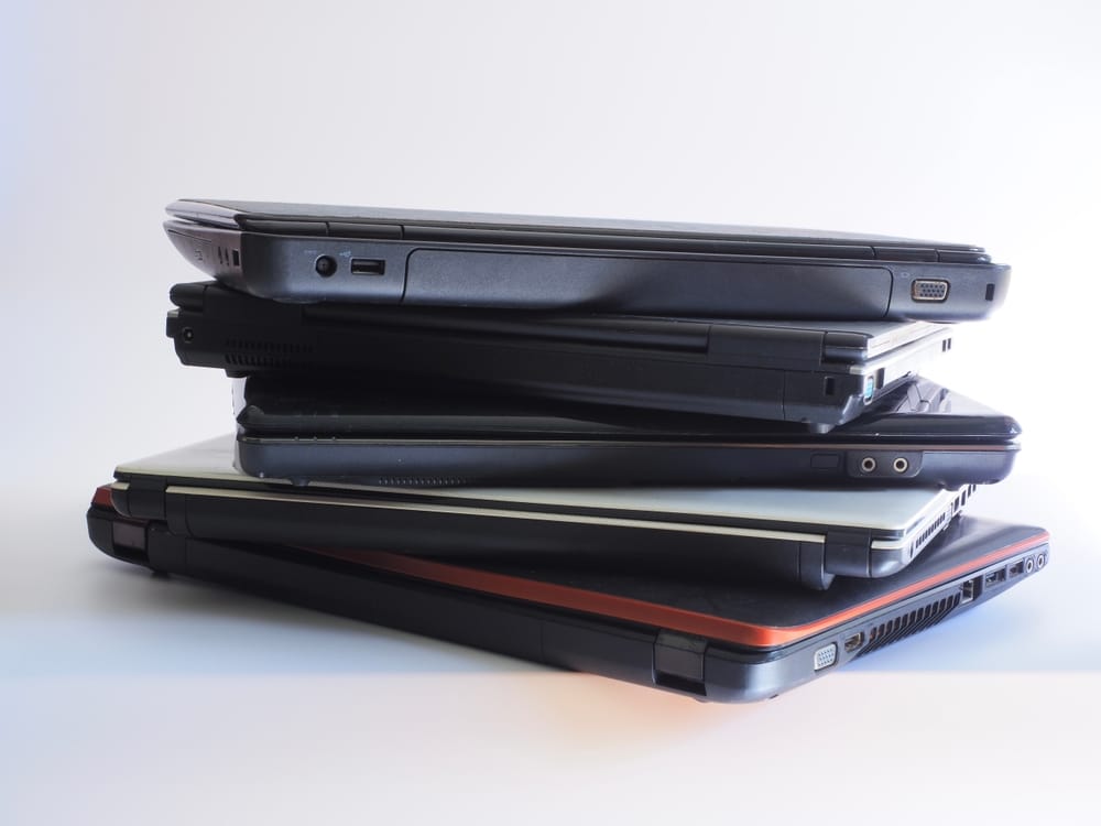 A view of a pile of old laptops to be disposed off