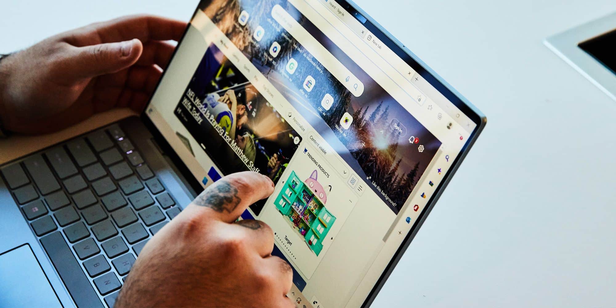 a person using his touch screen laptop